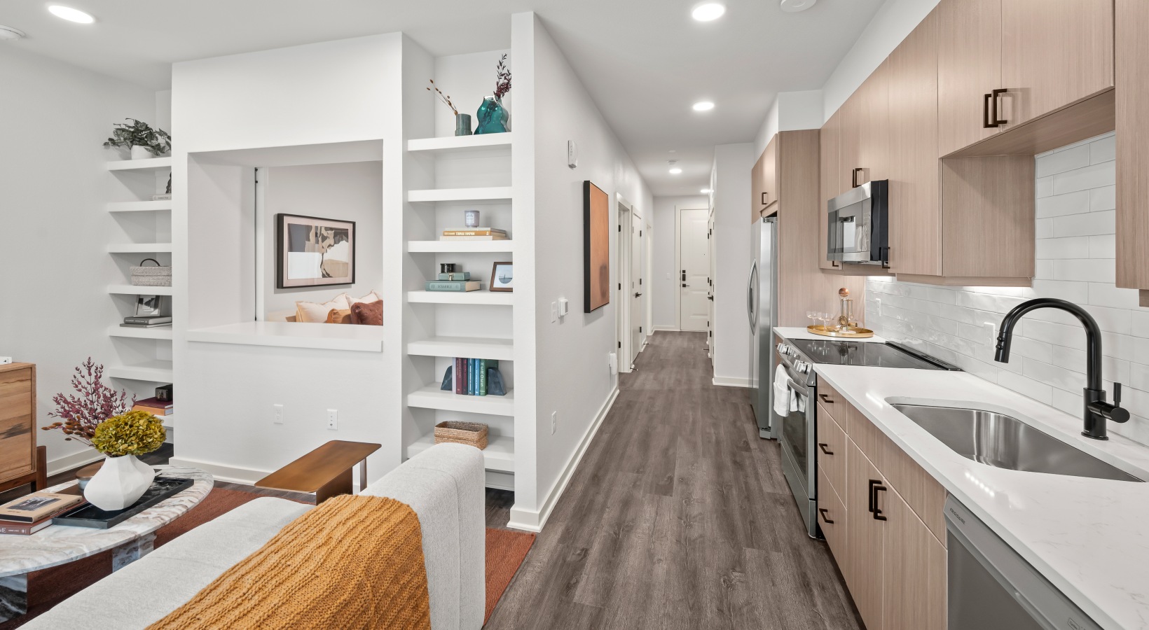 open concept floor plan open concept floor plan with wood flooring and built in shelving in the living room