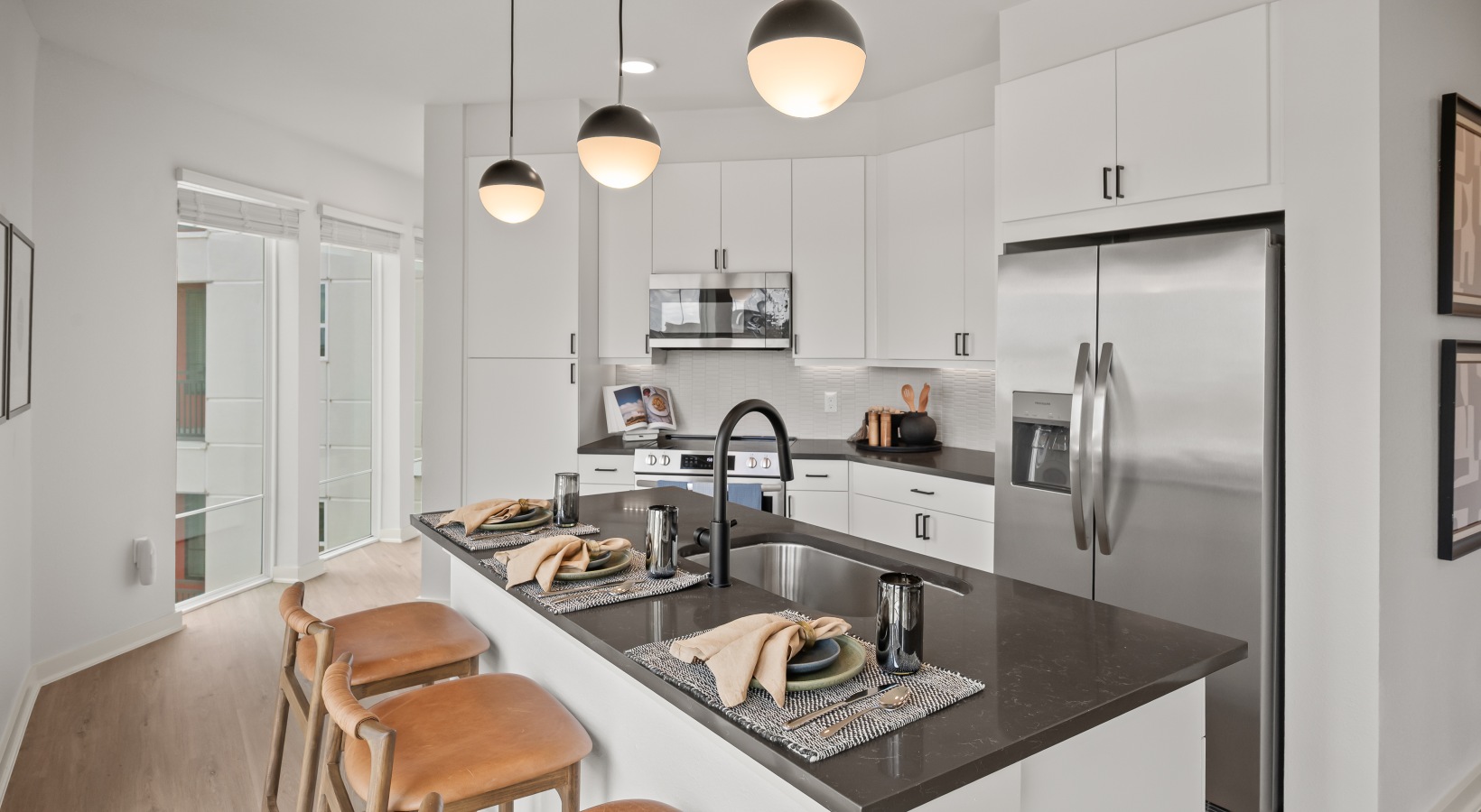 white cabinetry kitchen with stainless steel appliances 2 bedroom model kitchen with kitchen island and stainless steel appliances