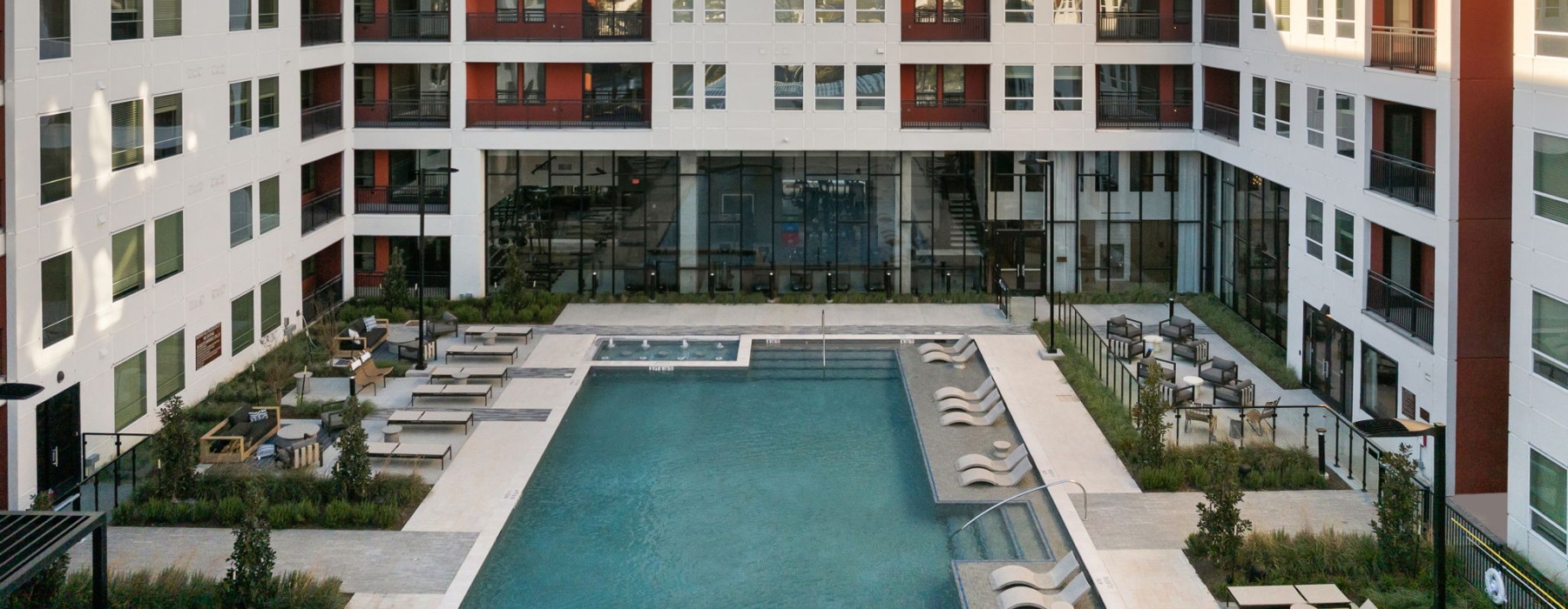 Resort-style swimming pool with lounge seating