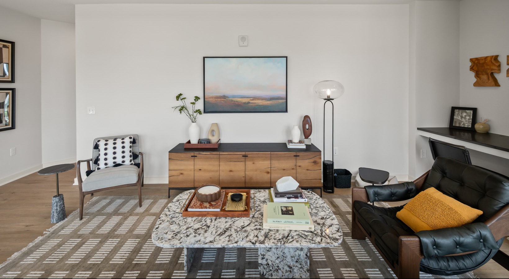 spacious living room with built in desk to work from home 2 bedroom model living room with wood flooring and built in desk