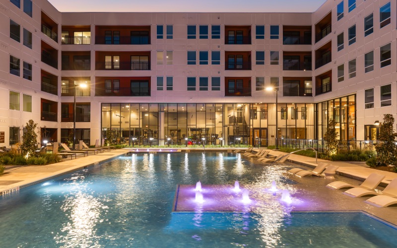 Sparkling swimming pool lit up at night