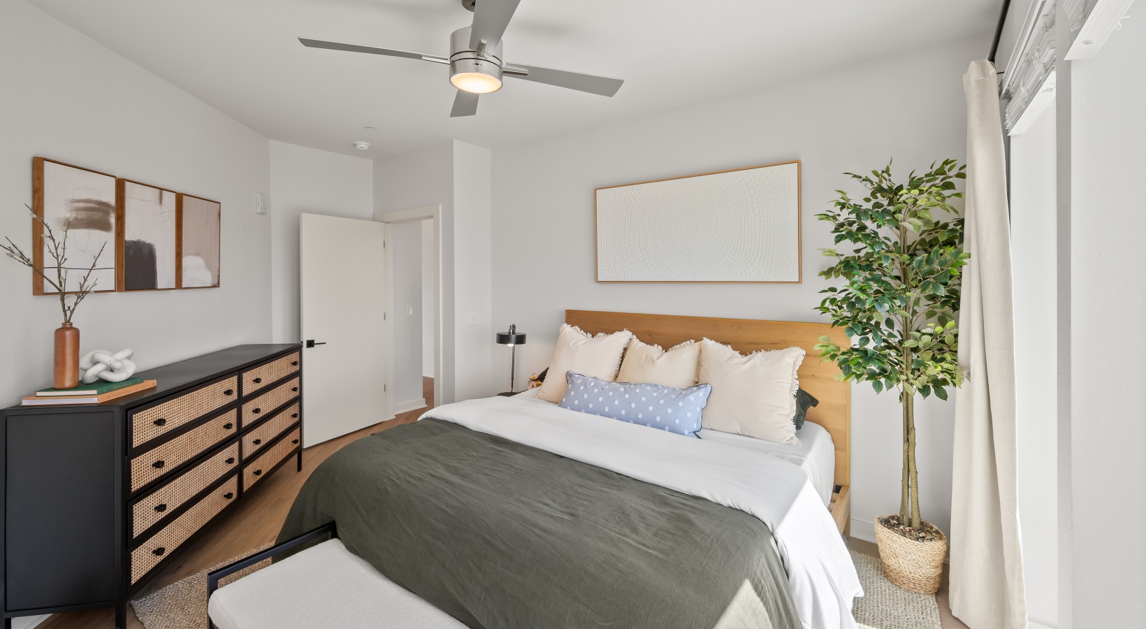 spacious bedroom  bedroom with wood flooring and ceiling fan