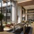 a spacious room with a table, big windows and chairs