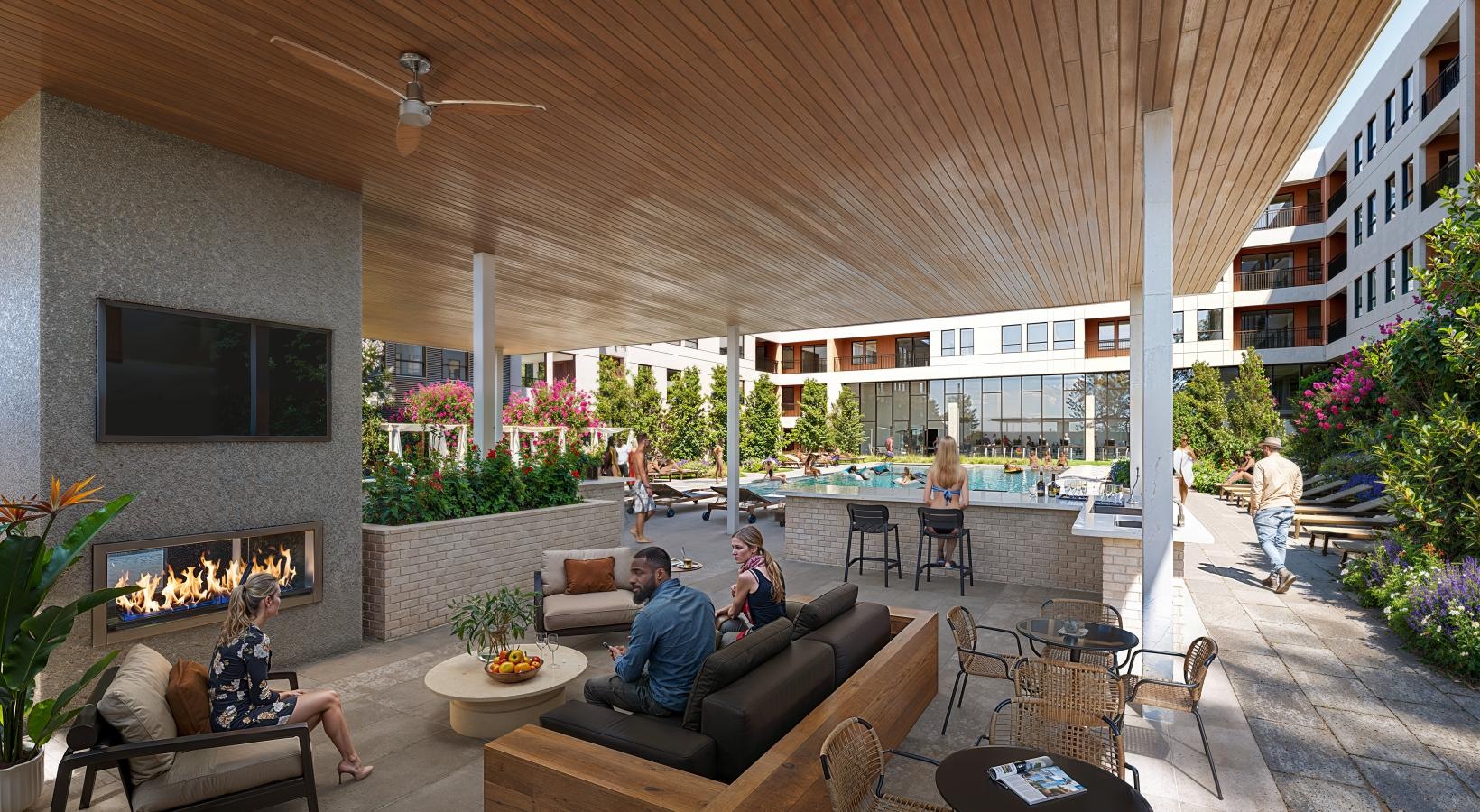 Relax and unwind poolside a man and woman sitting on a couch in a room with a fireplace