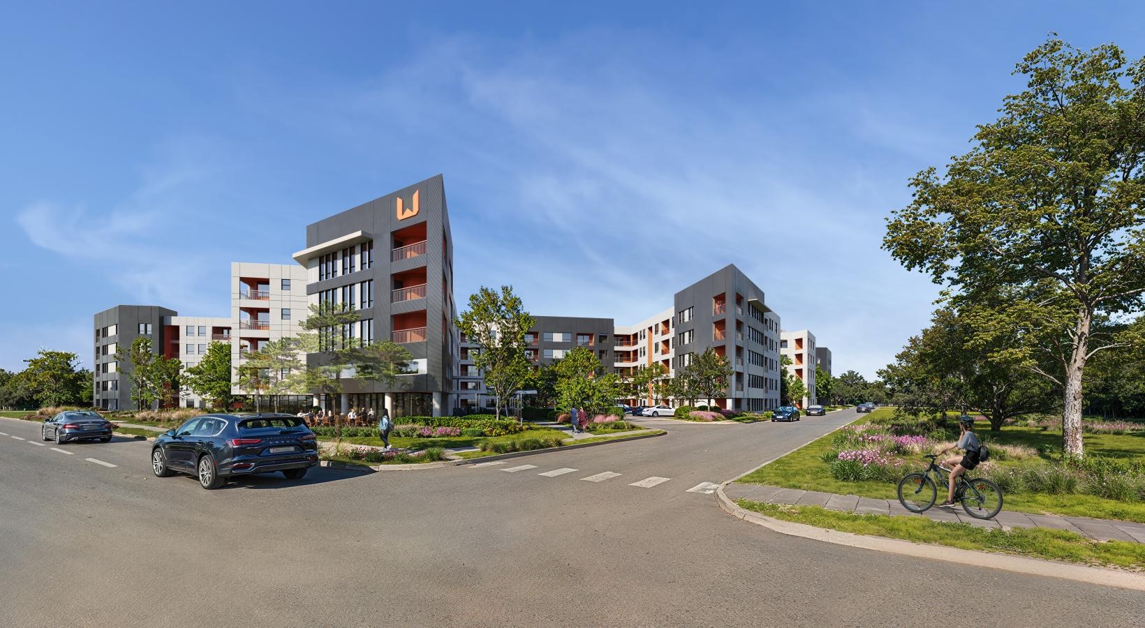 A beautiful community at the heart of all your passions a street with cars and buildings on the side